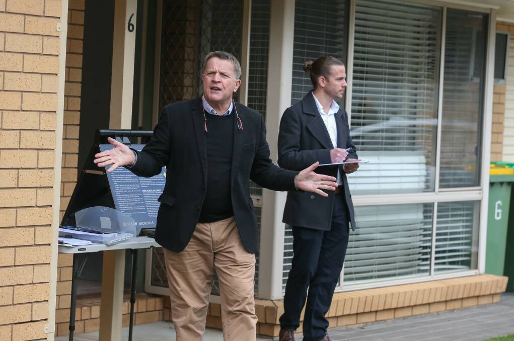 PASSED IN: Auctioneer Geoff Stean at the auction for a two-bedroom townhouse in Olive Street. Picture: TARA TREWHELLA