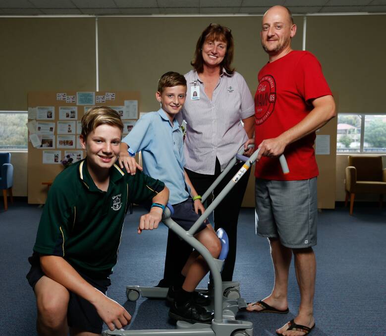 FINAL REQUEST: Samuel Miller, 11, sits in the new device alongside his brother Jacob, 14, his father Shane and nursing manager palliative care unit Linda Todhunter. Picture: MARK JESSER