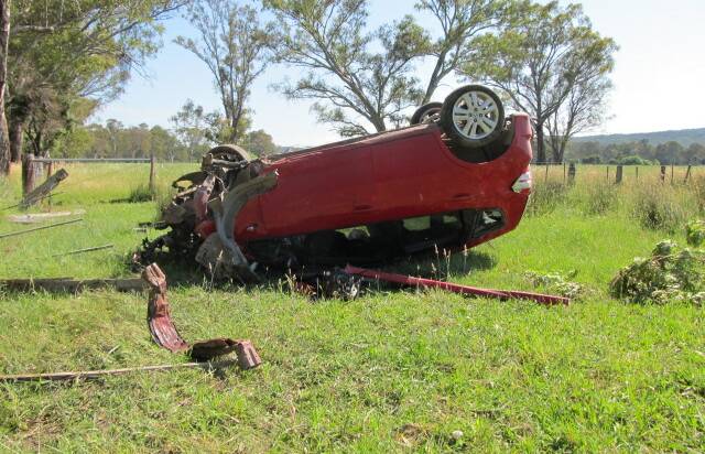 MESSY SCENE: Police arrived to find a trail of car parts and debris at an accident at Whitfield where a woman managed to escape with minor injuries. Picture: SUPPLIED