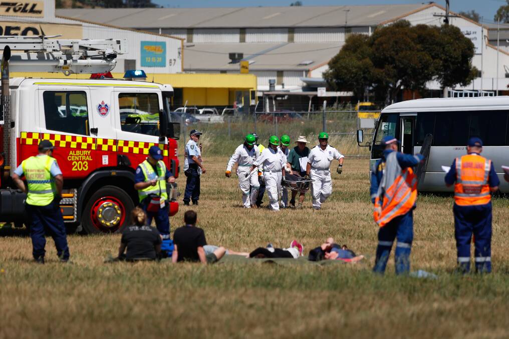 TEST RUN: All hands were on deck to organise a co-ordinated response to a simulated plane crash. Services looked to determine what happened and avoid unecessary risks. Picture: MARK JESSER