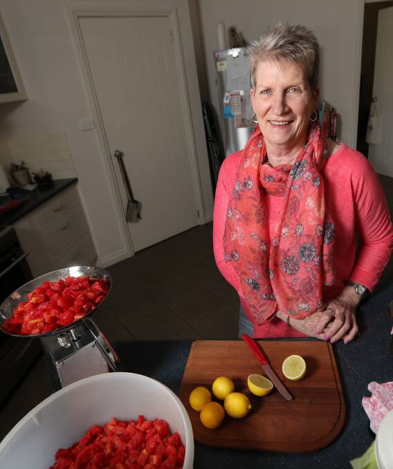 CHOPPING AWAY: Kay Blakeley slices lemon and dices tomato as she prepares another batch of relish to be sold to help fund McGrath breast care nurses. Pictures: JAMES WILTSHIRE 