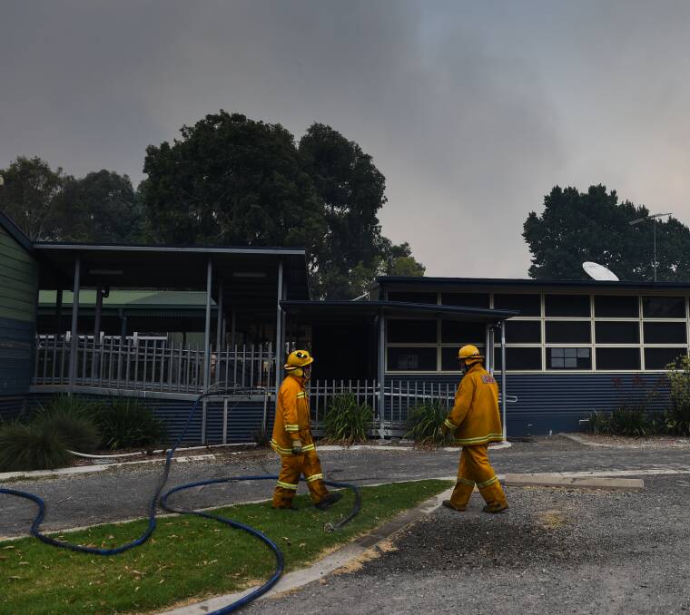 DEBRIEF: The hose was ready as firefighters debriefed a small group of people at the primary school on how to defend themselves against the flames.