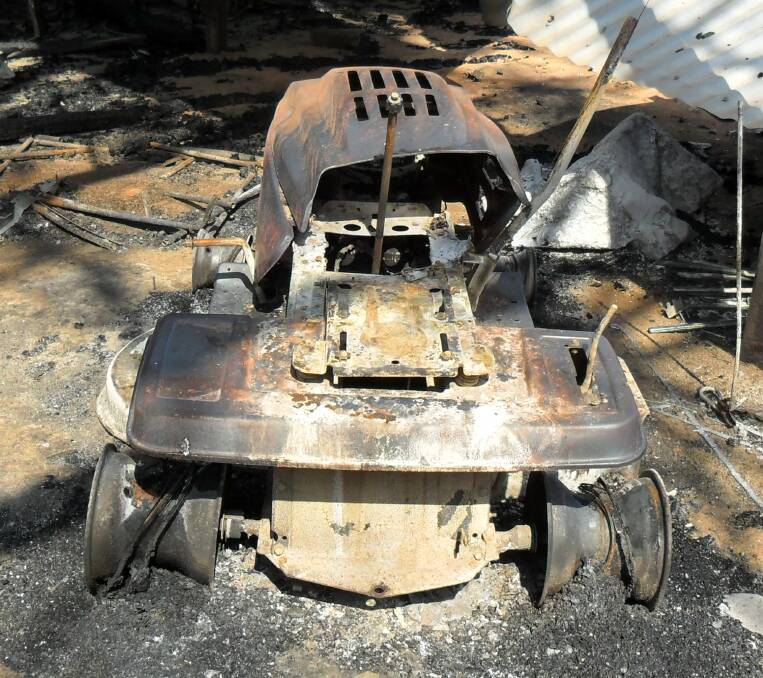 ASSESSING THE LOSS: Aaron Tait says he struggled to identify some of the items which were badly burned at his farm.