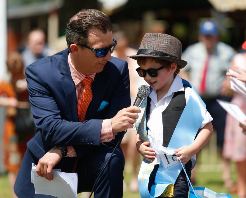 JUNIOR STAR: Quinn Battisson, 4, of Corowa, talks the crowd through his outfit at Corowa on Tuesday after he took out Master Junior Racegoer. Pictures: MARK JESSER