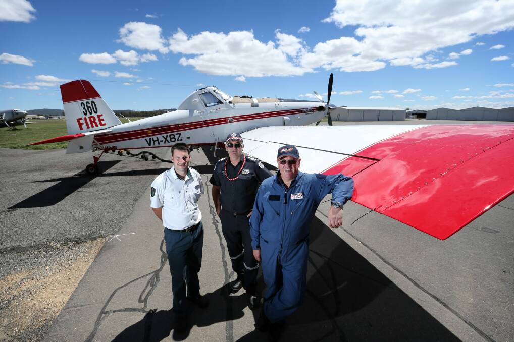 Jarrod Hayse from the DPI, Paul King and Stephen Death with a Fireboss water bomber that will be based at Albury airport to meet the seasons fire risks. Picture: MATTHEW SMITHWICK