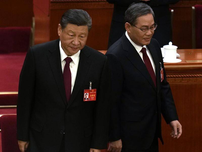 Chinese President Xi Jinping and Premier Li Qiang arrive for the opening session of congress. (AP PHOTO)