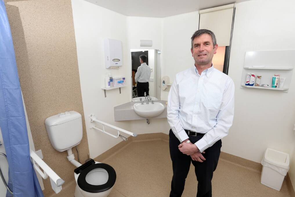 Cameron Butler in one of Beechworth’s soon-to-be refurbished bathrooms. Picture: PETER MERKESTEYN