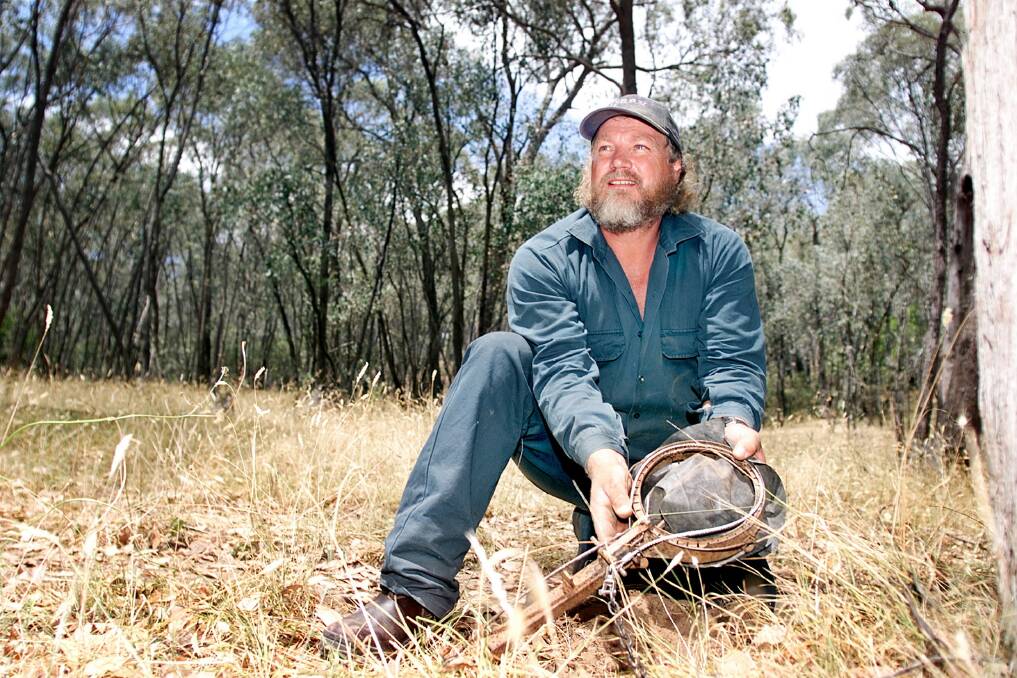 Dogman Brian McNamara in 2001 with a wild dog snare introduced by the department. They were later phased out.