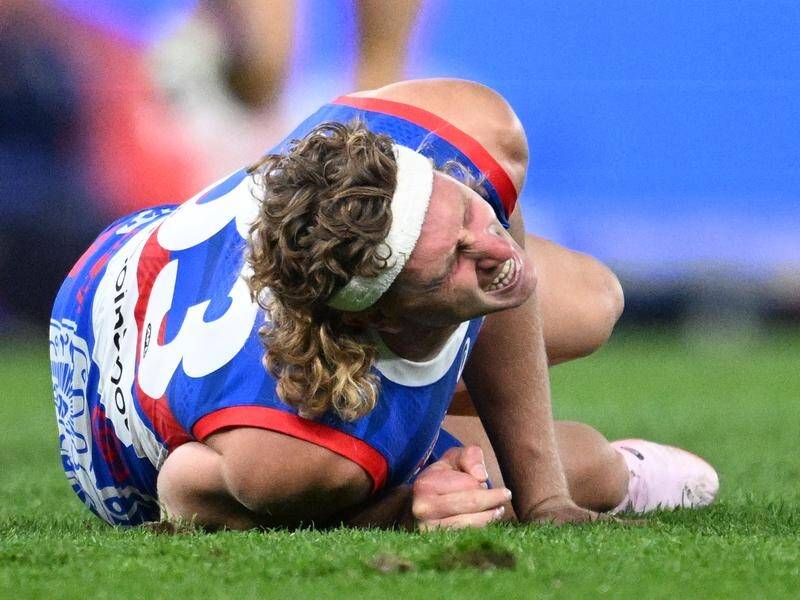 Western Bulldogs forward Aaron Naughton was in agony after his knee injury in the loss to the Swans. (Joel Carrett/AAP PHOTOS)