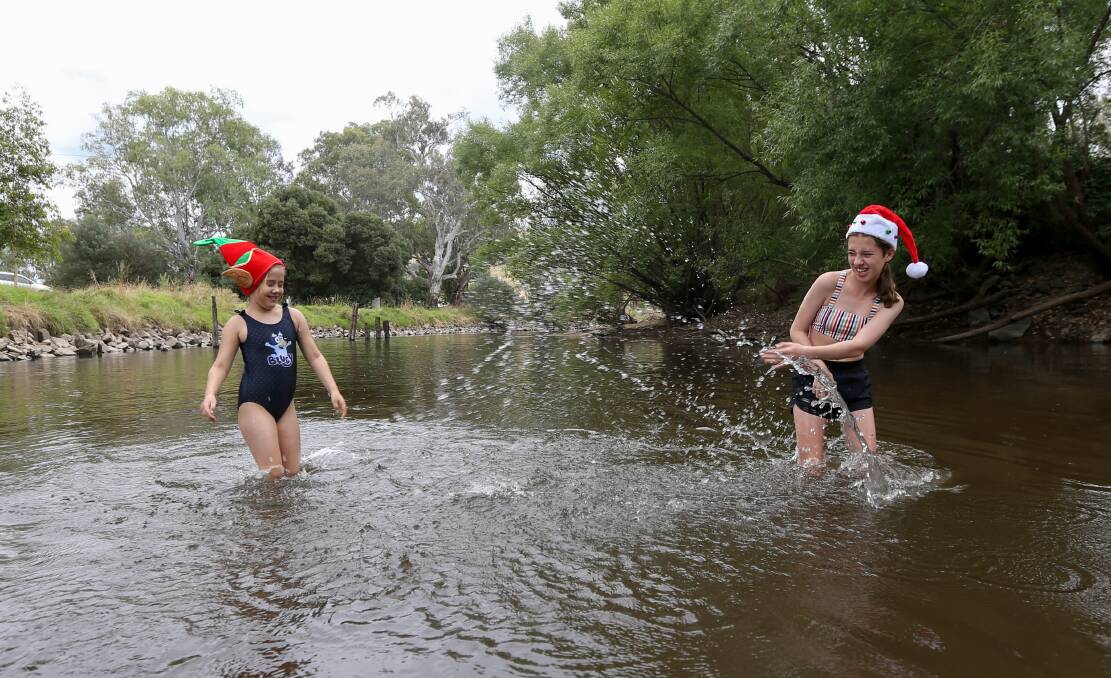 CELEBRATE: Claire McDonald, 7, and Lucinda Fitzgerald, 13. Rain is forecast for New Year's Eve this year. Picture: TARA TREWHELLA 