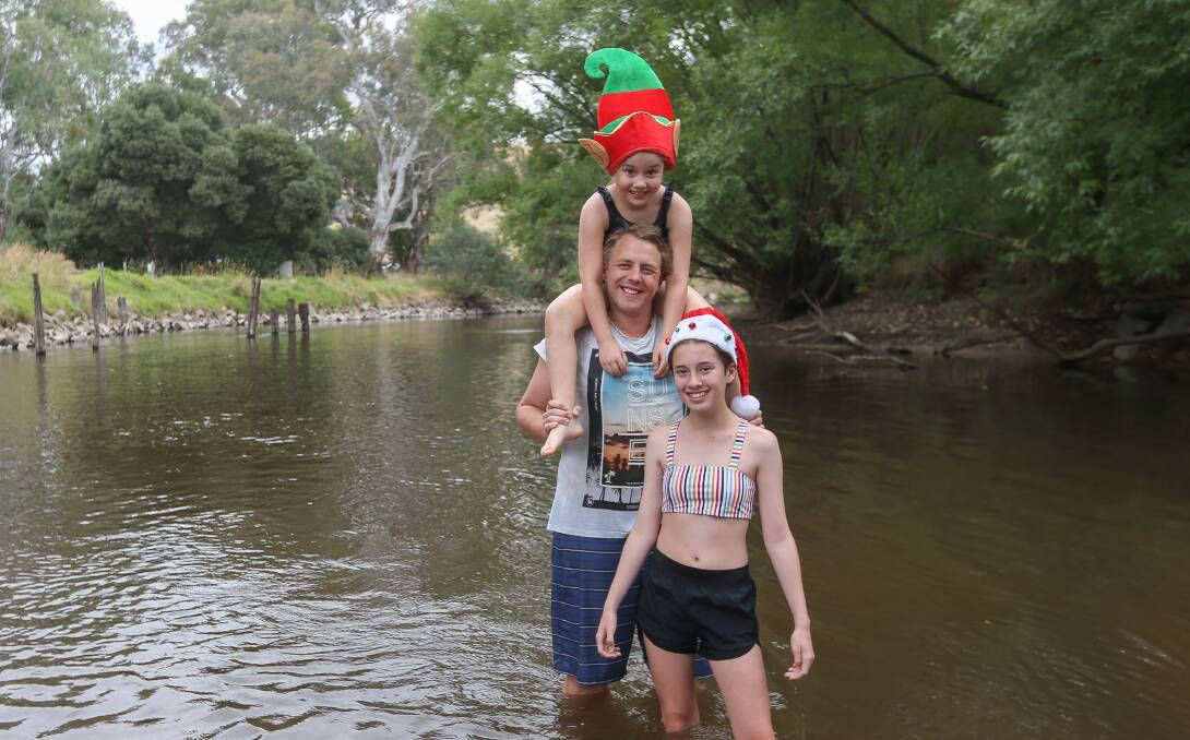 JOY: Claire McDonald, 7, Lachlan McDonald and Lucinda Fitzgerald, 13, cool off in the Murray River. Temperatures of 30 degrees are expected on New Year's Eve. Picture: TARA TREWHELLA 