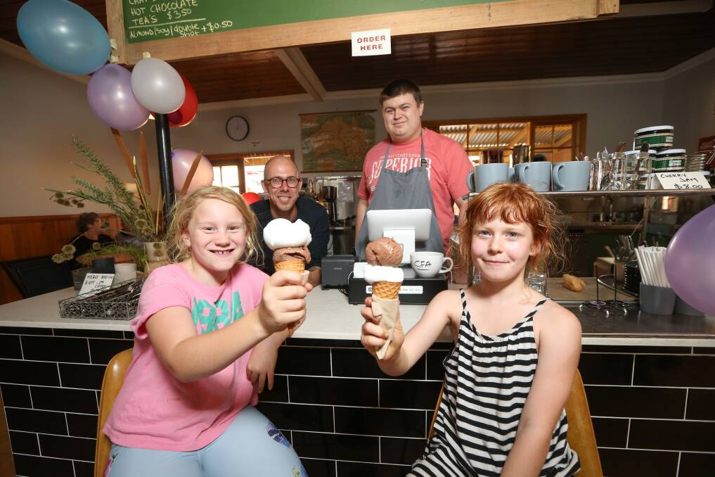 INCLUSIVE: Vivienne O'Brien, 8, and Jaala Street, 8, at Scoop 21 with owner Stefan Heintjes and employee Nik Vukasinovic. Picture: JAMES WILTSHIRE 