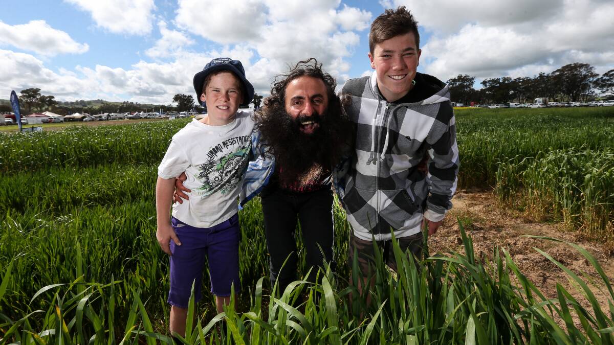 PASSIONATE: Brothers Brynn and Morgan Mitsch meet Costa Georgiadis at the Henty Machinery Field Days on Tuesday. Picture: JAMES WILTSHIRE