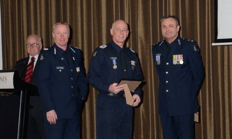 AWARD: Asistant Commissioner Rick Nugent, Senior Sergeant Doug Incoll and Superintendent Paul O'Halloran at the ceremony. 