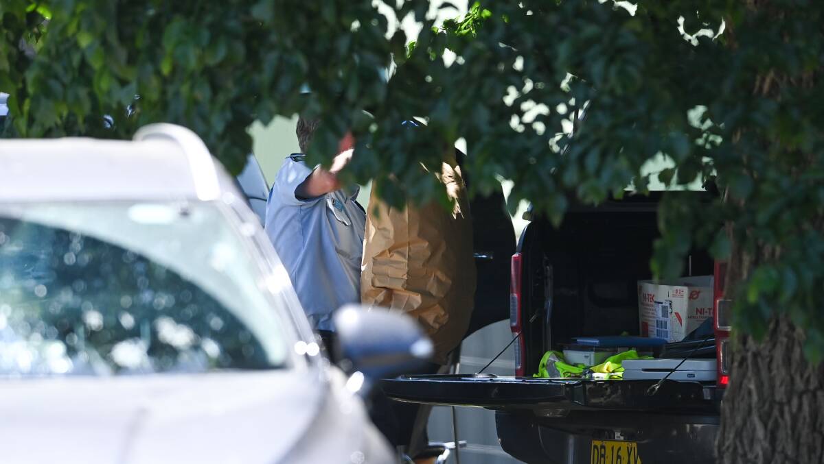 Police remove bags of evidence from a Thurgoona home after the shooting. Picture by Mark Jesser