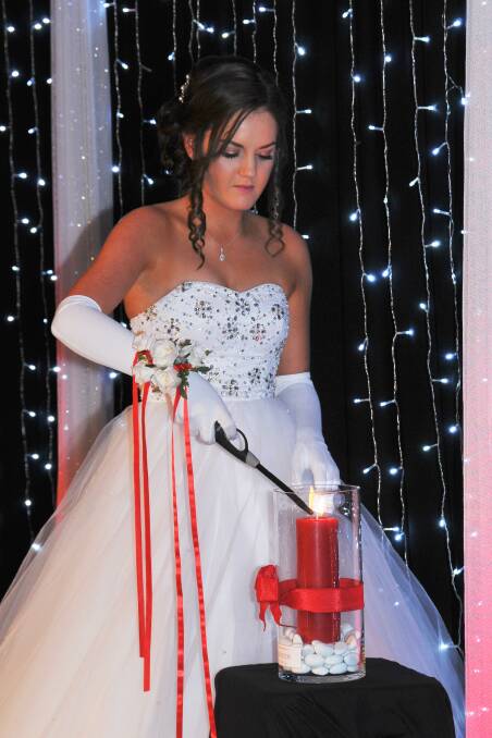 FLAME: Rylea Brooks lights a candle in memory of Spencer. Picture: DYANNE PHOTOGRAPHY 