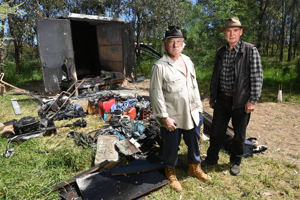 Landcare volunteers Kelvin Berry and Tony Lane with the burnt out container in Wangaratta. Picture by Mark Jesser