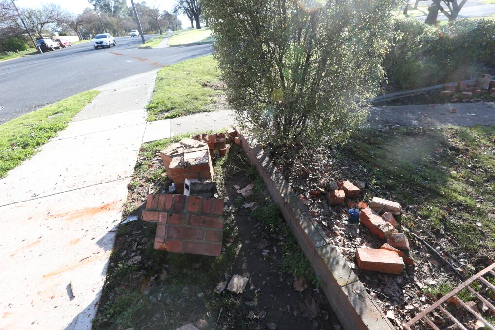 The scene of the crash on David Street in Albury on Tuesday morning. Tyre marks can be seen leading to the damaged fence, top left. Picture by Blair Thomson