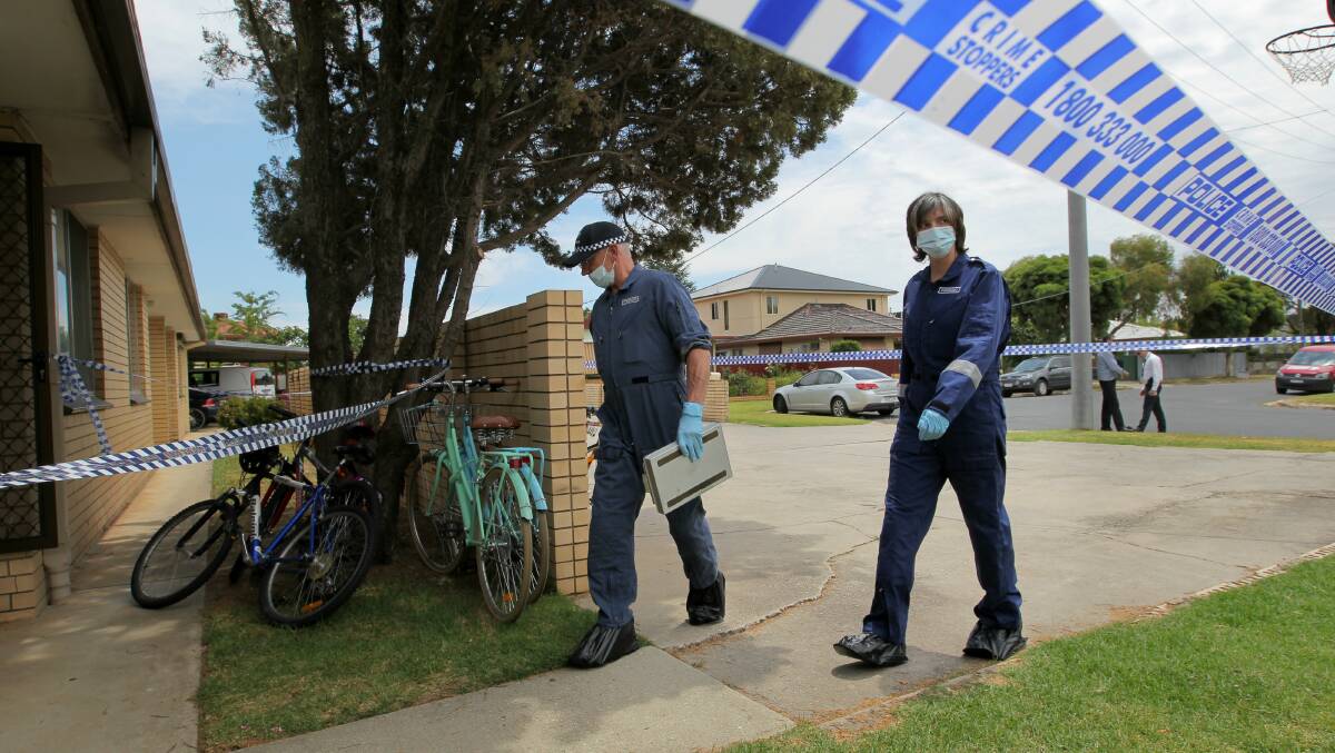 CRIME SCENE: Forensic officers arrive at the Wodonga unit. Picture: BLAIR THOMSON