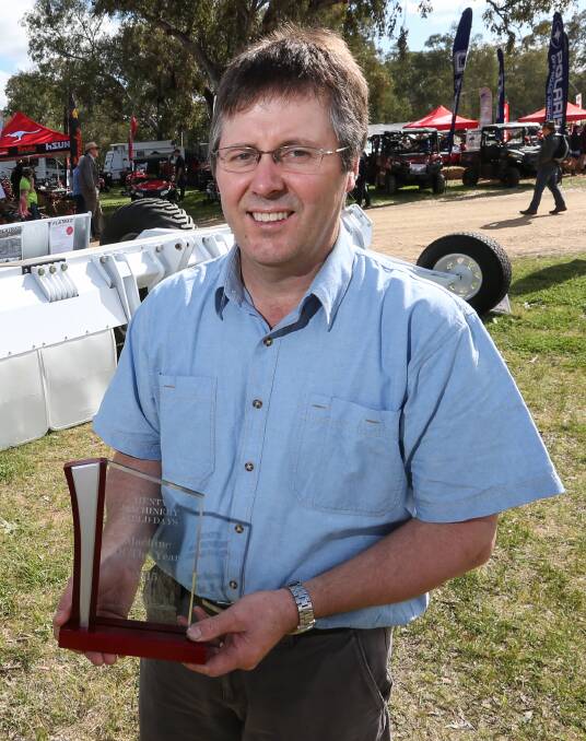 WINNER: Neale Postlethwaite with his award for the Henty machine of the year.