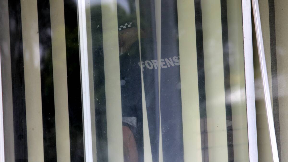 CRIME SCENE: A forensic officer inside the home. Picture: BLAIR THOMSON