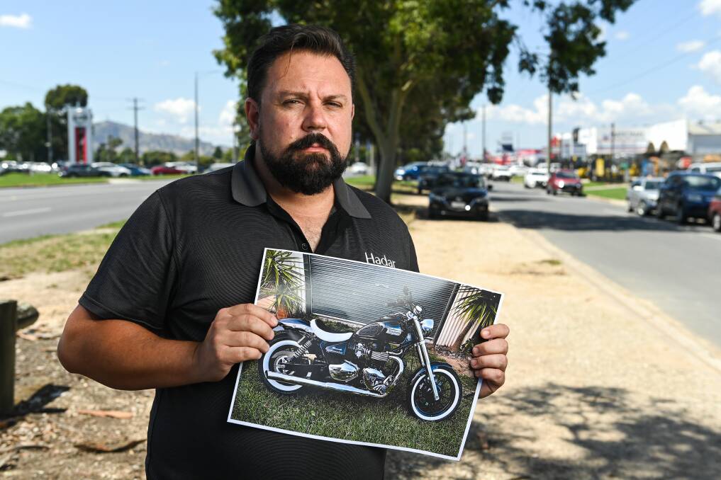 Mr Cartwright with an image of the stolen Triumph. File photo