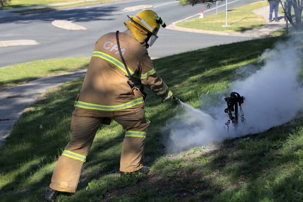 A CFA member extinguishes the blaze with dry powder. Picture: BLAIR THOMSON
