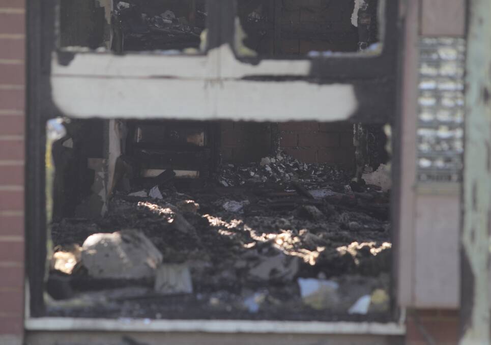 REMAINS: Charred remnants from the interior of the home can be seen inside the Logan Road property. Windows in the house were blown out during the fire. 