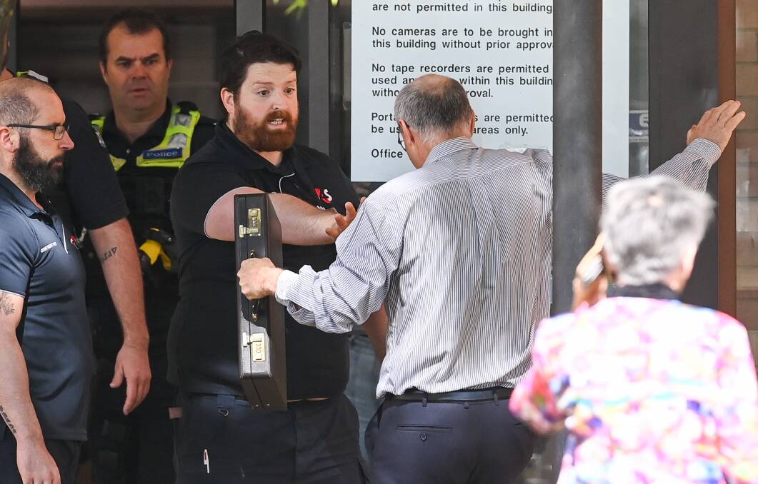 Eric Robert Lord is forced out of Wodonga court by security guards on Tuesday after refusing to leave. 