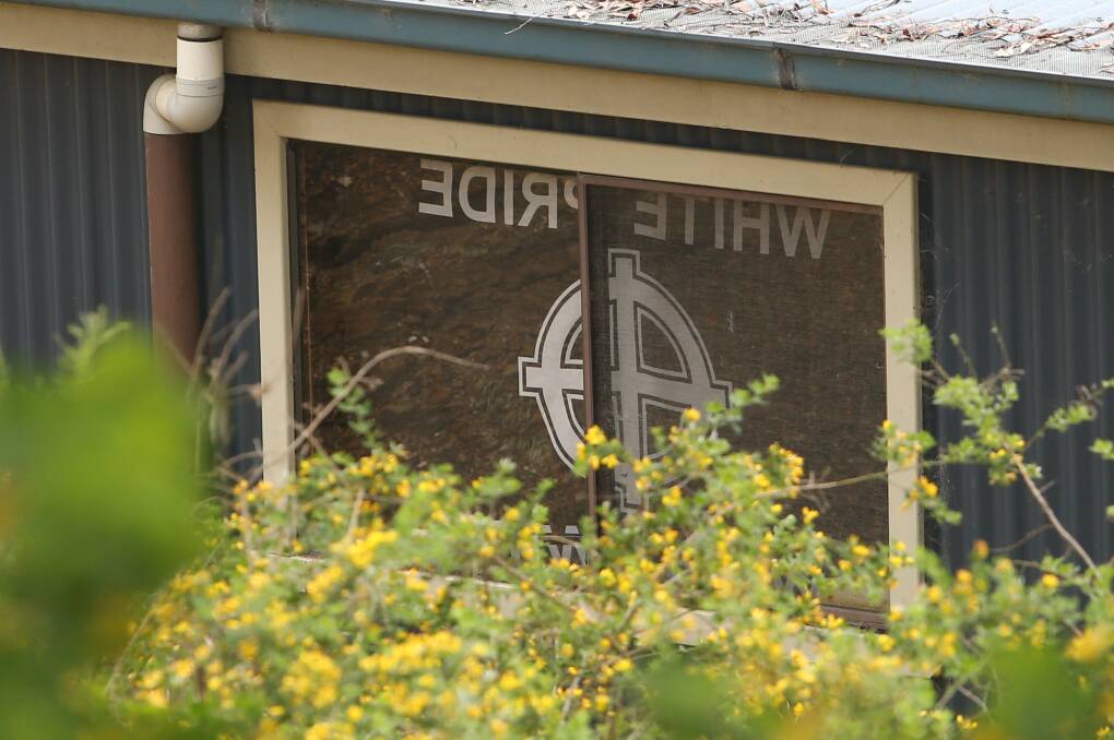 A shed at the Buckland Gap Road property features a white nationalist flag. 
