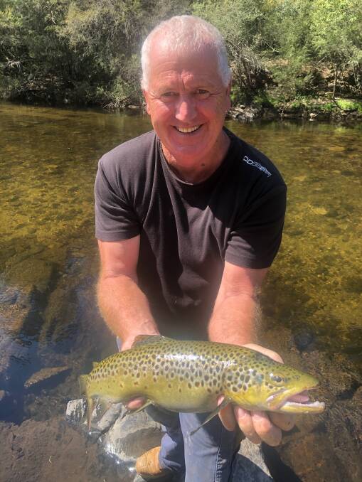 NICE ONE: Ross McHenry pictured with a great trout caught in the Mitta Valley.