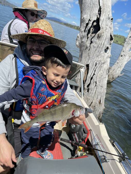 A FIRST: Two-year-old Mahmoud with his uncle Johnny and his very first redfin at Lake Hume.