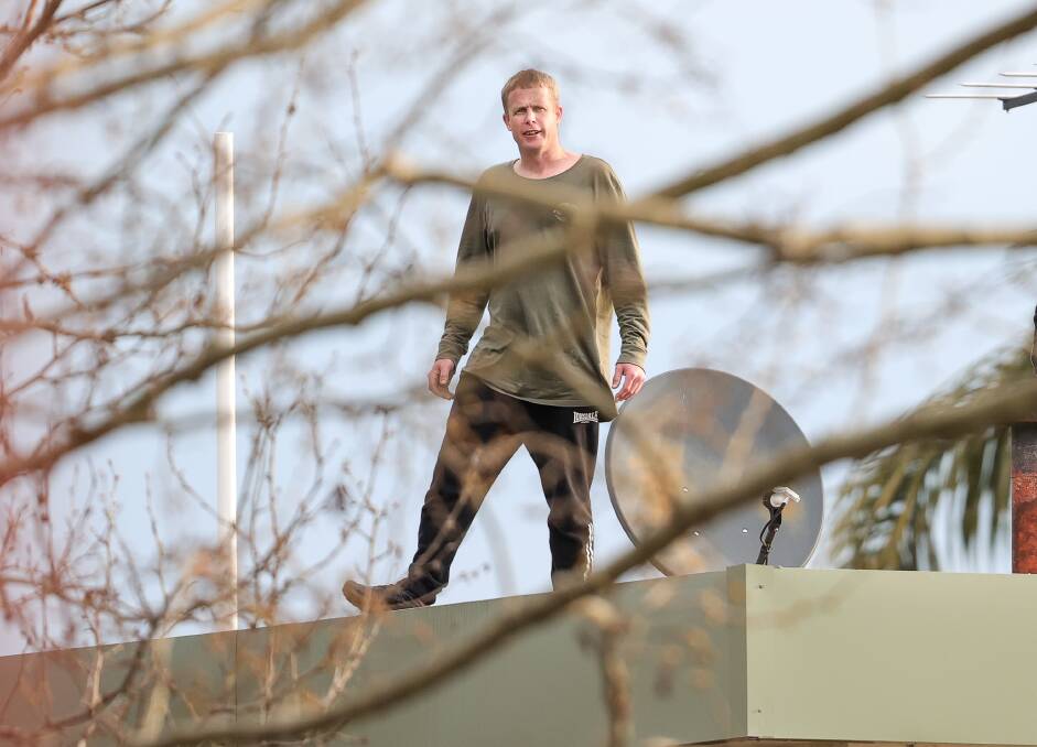 Ben Quigley on the roof of Albury's Burvale Motor Inn on Monday afternoon. Picture by James Wiltshire