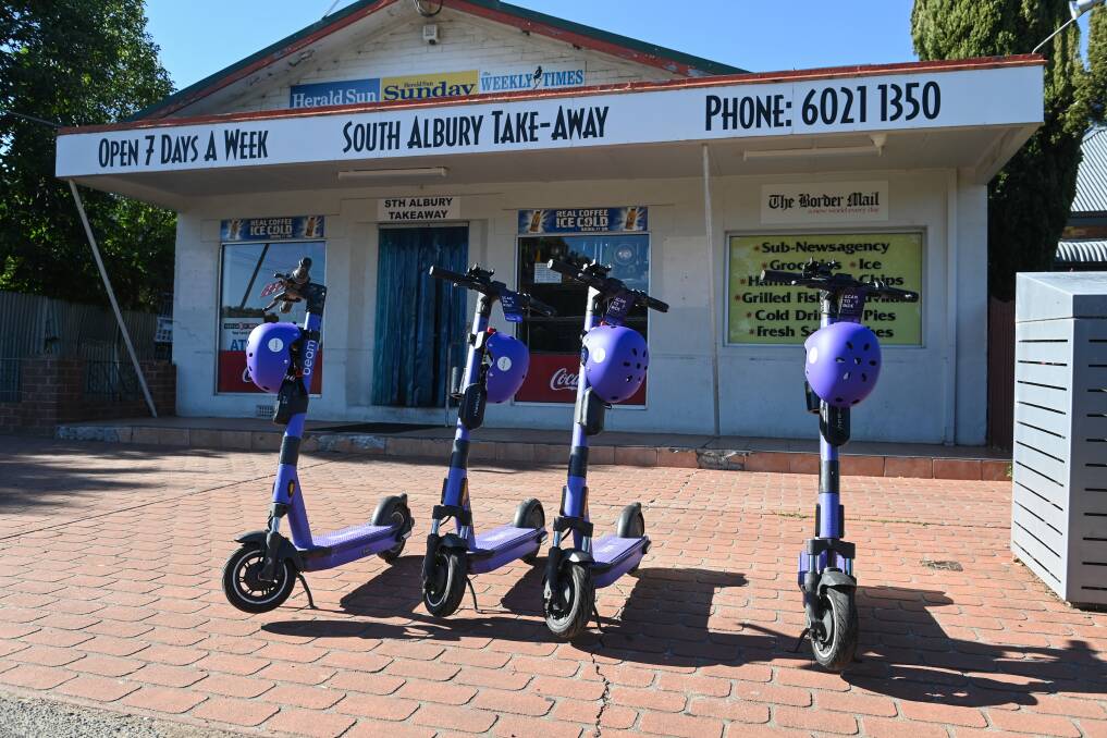 Four e-scooters sit outside the South Albury Take-Away on Ebden Street. Picture by Mark Jesser