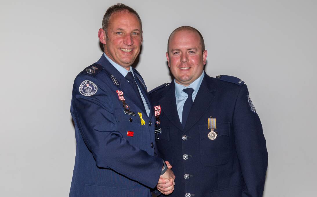 WELL DONE: CFA deputy chief officer Steve Warrington congratulates Wodonga Fire Brigade second lieutenant Rowan Montoneri on his National Medal, which recognises 15 years of diligent service. Picture: MARK SLATER