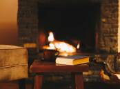 Spending a cosy evening next to the fire with a book and a cuppa is one way to get through the current cold wintry conditions. Picture by Shutterstock
