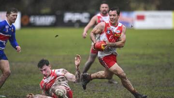 The mud is flying as Chiltern's Nicholas Stephens and Parker Phelan navigate the heavy conditions during their Tallangatta and District Football League match against Thurgoona on Saturday, July 20. Picture by Mark Jesser