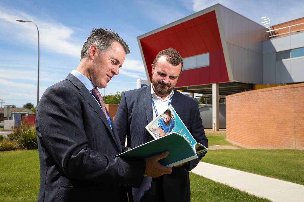 Albury Wodonga Health chief executive Bill Appleby and chairman Jonathan Green look over the health service's new strategic plan. Picture by James Wiltshire
