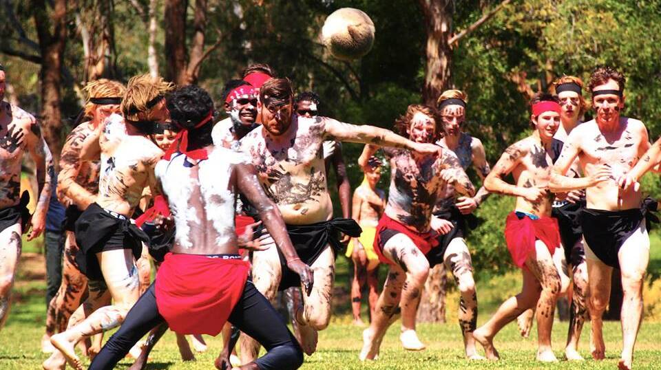 PLAY ON: Competitors surge towards the ball in the annual Marngrook match. This year's game will be held on the weekend to increase community involvement.