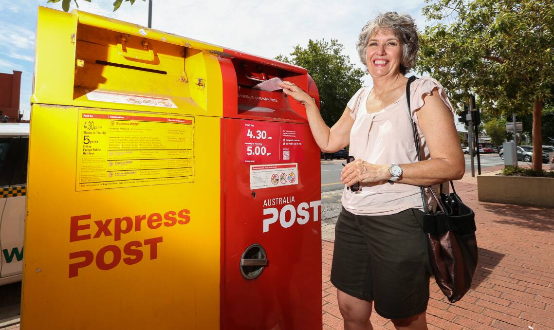 MAIL TIME: Wodonga's Lynne Fielder posts a letter this week, ahead of changes to Australia Post's delivery system that take effect on Monday. Regular stamps will rise to $1 while priority delivery will be $1.50. Picture: JAMES WILTSHIRE