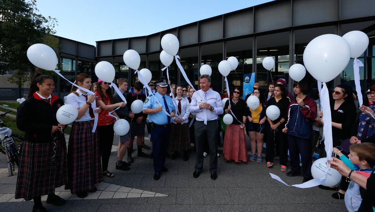 STANDING TOGETHER: Participants in Thursday's Fly A White Balloon activities prepare to release balloons to raise awareness of child abuse. Picture: MARK JESSER