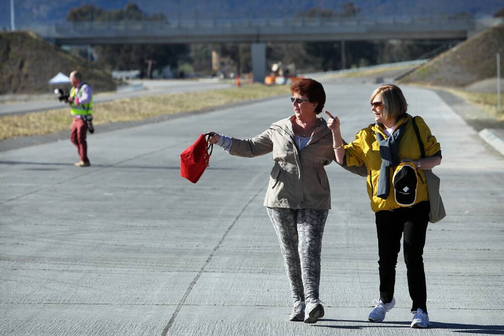 Nelma Hawk and Glenys Lotter, of Holbrook, took advantage of being able to take a walk on the new road at the official opening of the Hume Freeway bypass of Holbrook yesterday.