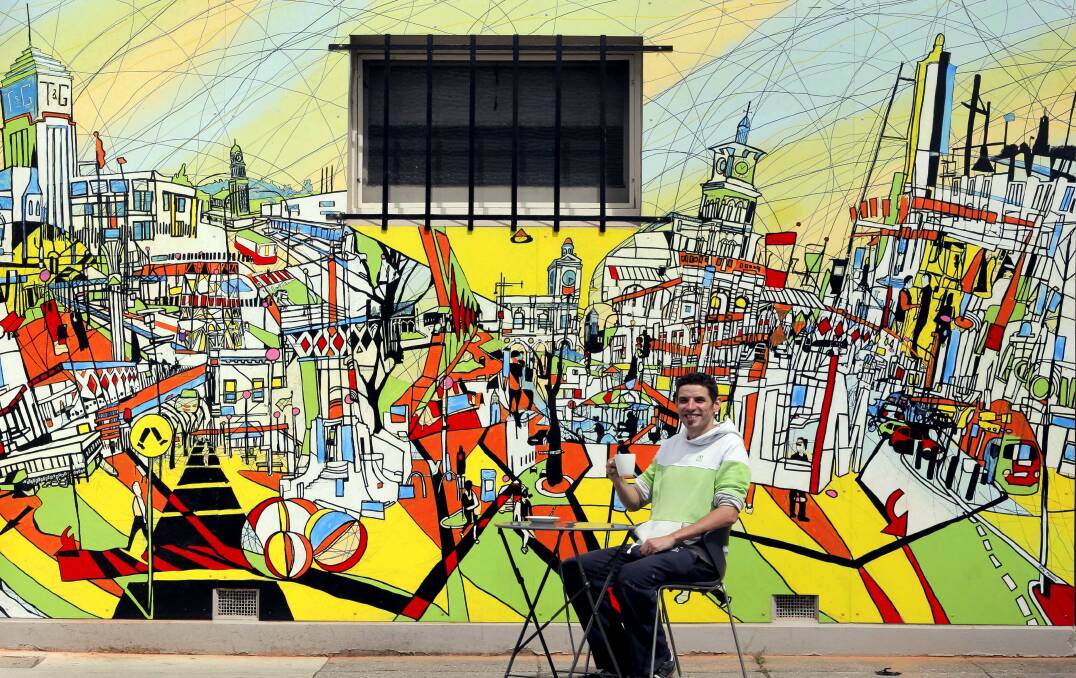  Local artist Dan Mahon with his Albury street scape mural which he painted outside Zo'i Espresso. Pictures: TARA GOONAN