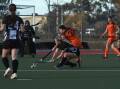Magpies' Tahlia Rekunow (crouching) and Falcons' Kate Hughes battle for possession. Picture by Hockey Albury Wodonga